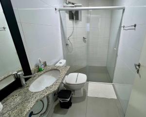 a bathroom with a toilet and a sink and a shower at Edifício Madrid | Ayrton Senna in Toledo