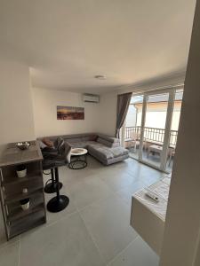 a living room with a couch and a table at Andrejić 1 in Veliko Gradište