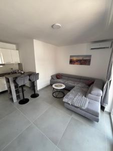 a living room with a couch and a table at Andrejić 1 in Veliko Gradište +12 photos