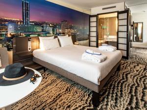 a hotel room with a bed and a city skyline at Novotel Paris 14 Porte d'Orléans in Paris +95 photos