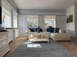 a living room with a couch and a coffee table at Deichhof Whg Luana in Dunsum