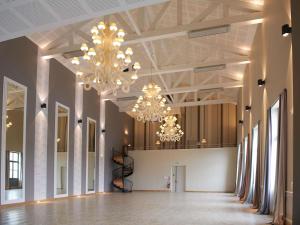a large room with chandeliers hanging from the ceiling at Mercure Cholet Centre in Cholet