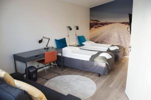 een hotelkamer met 2 bedden, een bureau en een weg bij Autokeidas Forssa Motelli in Forssa