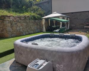 a hot tub in the middle of a yard at Къща Владислав in Radevtsi