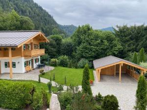 a house in the middle of a garden at Chalet Vogelnest am Waldbach in Reit im Winkl