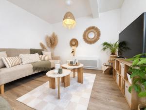 a living room with a couch and two tables at Appartement cosy Beaupréau centre in Beaupréau
