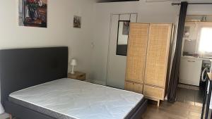 a bedroom with a bed in a room at Studio Oustaou à Château Gombert in Marseille