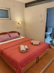 a bedroom with a bed with two towels on it at Apartmani Ribar in Ohrid