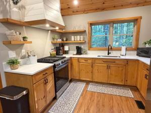 a kitchen with wooden cabinets and a stove top oven at Honey Ridge Forest Retreat in South Bloomingville