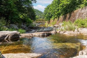 a river with rocks and trees in the background at Pocheon Terrace 527 Campground in Pocheon