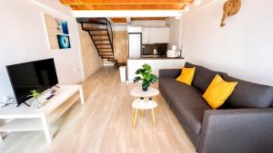 a living room with a couch and a table at Vientos de Tabarca 4 in Tabarca +39 photos