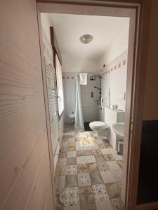 a bathroom with a toilet and a sink at Damodoro Hotel in Pordenone