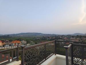 a balcony with a view of a city at Henderson Homes Uganda in Sisa