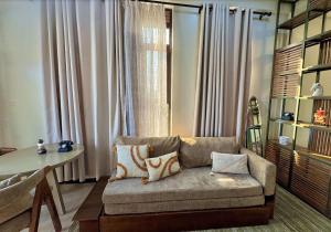 a living room with a couch and a table at Henderson Homes Uganda in Sisa