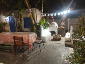 a patio with a table and a fire place at Elvira's natural lodge in Burzaco