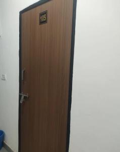 a wooden door with a sign on it at Hotel Hidden Gem in Pānīpat