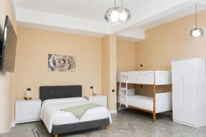 a bedroom with a bed and a bunk bed at Gazulli Guesthouse in Lezhë