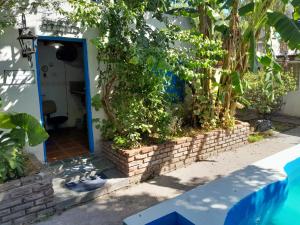 a entrance to a house with a blue door at Elvira's natural lodge in Burzaco