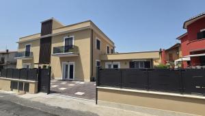 a house with a black fence in front of it at Dimora Clorinda in Passo Corese