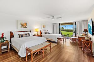 a hotel room with two beds and a balcony at Maui Eldorado Condo J123 in Kaanapali +34 photos