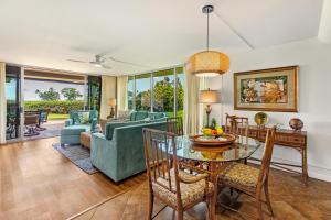 a living room with a table and chairs at Maui Eldorado Condo J123 in Kaanapali