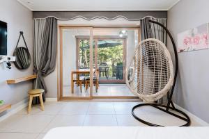 a room with a fan and a dining room at Samcheok The Ggeullim Pension in Samcheok