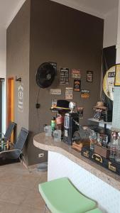 a kitchen with a counter with a coffee maker on the wall at Rancho do Mirante in Araçatuba