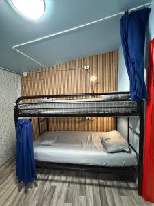 two bunk beds in a room with blue curtains at OQP Hostel Miami in Miami +55 photos