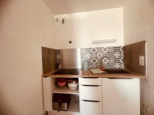 a small kitchen with a counter and a sink at CaroCarnon in La Celle-sous-Gouzon