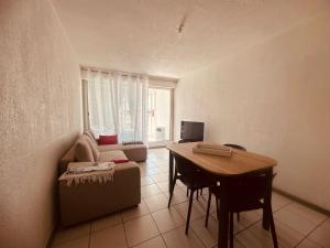 a living room with a couch and a table at CaroCarnon in La Celle-sous-Gouzon