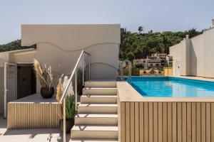 a staircase leading up to a house with a swimming pool at Palatino Hotel in Zakynthos