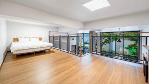 a bedroom with a bed and large glass windows at Gapyeong Sungshine Pension in Gapyeong