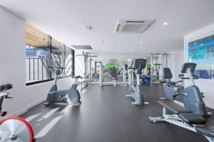 a gym with several treadmills and cardio machines at Bright CBD 2 bedroom resort-style escape in Brisbane