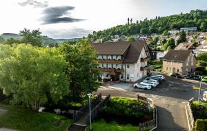 a town with cars parked in a parking lot at Hotel Restaurant Schwörer in Lenzkirch