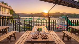 a table on a deck with a view of the water at Gapyeong Sungshine Pension in Gapyeong +4 photos