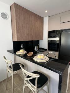 a kitchen with a black counter with two plates on it at Jardins de carthage in Tunis