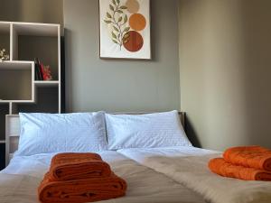 two towels on a bed in a bedroom at Mini home apartment in Ternopil +7 photos