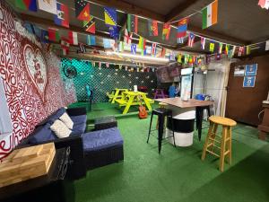 a room with a couch and a table and flags at OQP Hostel Miami in Miami