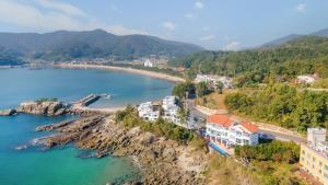 an aerial view of a town next to a body of water at Namhae Opera House Pension in Namhae