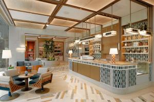 a lobby of a hotel with a bar and chairs at Canopy By Hilton Bangkok Sukhumvit in Bangkok