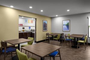 a restaurant with tables and chairs and a counter at Hampton Inn Terre Haute in Terre Haute