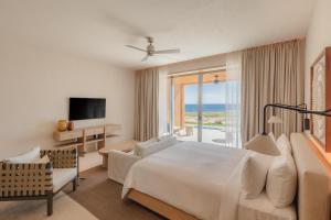 a hotel room with a bed and a large window at Park Hyatt Cabo Del Sol in Cabo San Lucas +98 photos