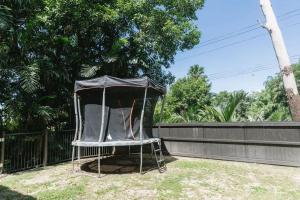 a chair with a covering sitting in a yard at The Treehouse - Rainforest Home - Pool in Smithfield