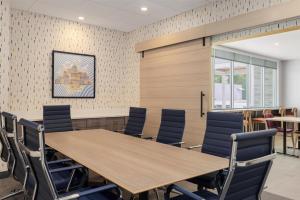a conference room with a wooden table and chairs at Home2 Suites By Hilton Springfield in Springfield +36 photos
