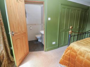 a bathroom with a bed and a toilet in a room at Banklands in Barnard Castle +27 photos