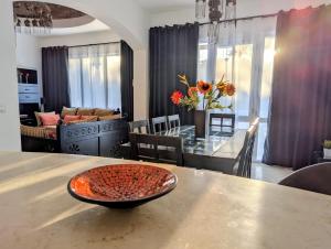 a dining room and living room with a dining table at Private Villa Heated Pool & Enclosed Garden in Hurghada