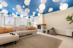 a living room with a couch and a blue ceiling at Portugal Active Cabedelo Beach Lodge - Heated Pool in Viana do Castelo
