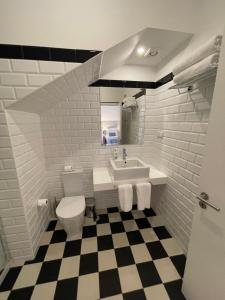 a white bathroom with a sink and a toilet at PIER HOUSE Accommodation in Funchal +83 photos