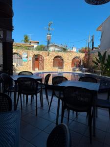 a patio with tables and chairs and a pool at Pousada Ocean Mare in Praia do Frances