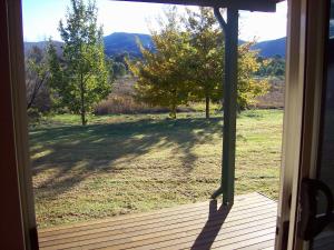 an open door of a porch with a view of a field at Colonial Inn Guest Rooms in Yackandandah